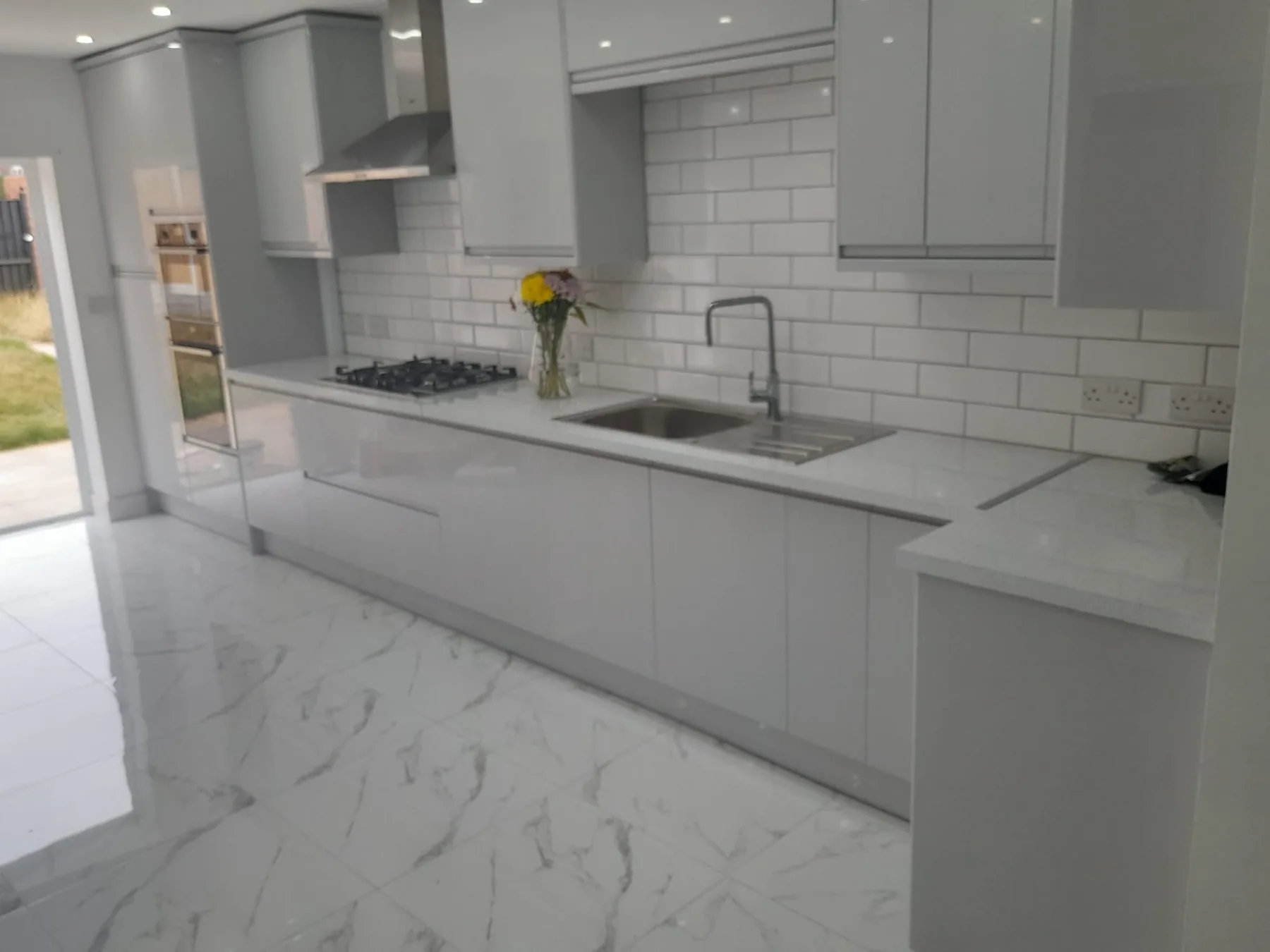 Completed light grey fitted kitchen by Campbell and Sons