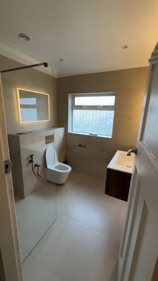 Completed light tiled bathroom